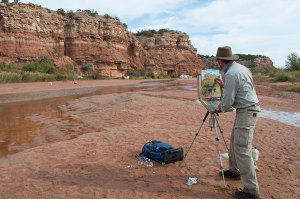 Pete Quaid painting the cliffs on the Pease River